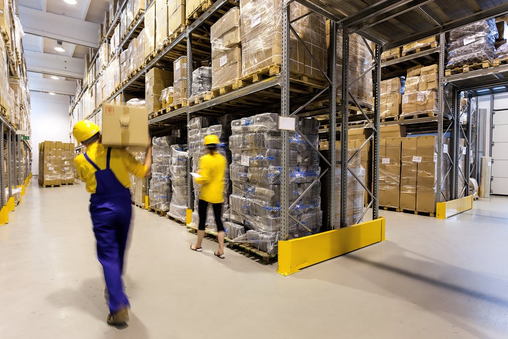 Warehouse worker with box and manager controlling products-2